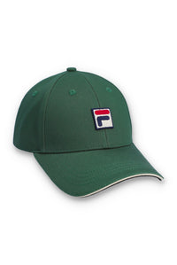 A dark green baseball cap featuring a small embroidered Fila logo patch on the front, set against a plain white background.