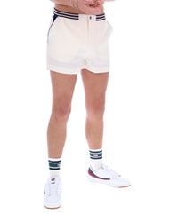 Person wearing white shorts with a striped waistband on a white background