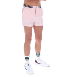 Person wearing light pink shorts with a striped waistband on a white background
