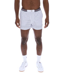 Person wearing white checkered shorts with black stripes on a white background