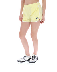 Person wearing yellow mesh shorts on a white background
