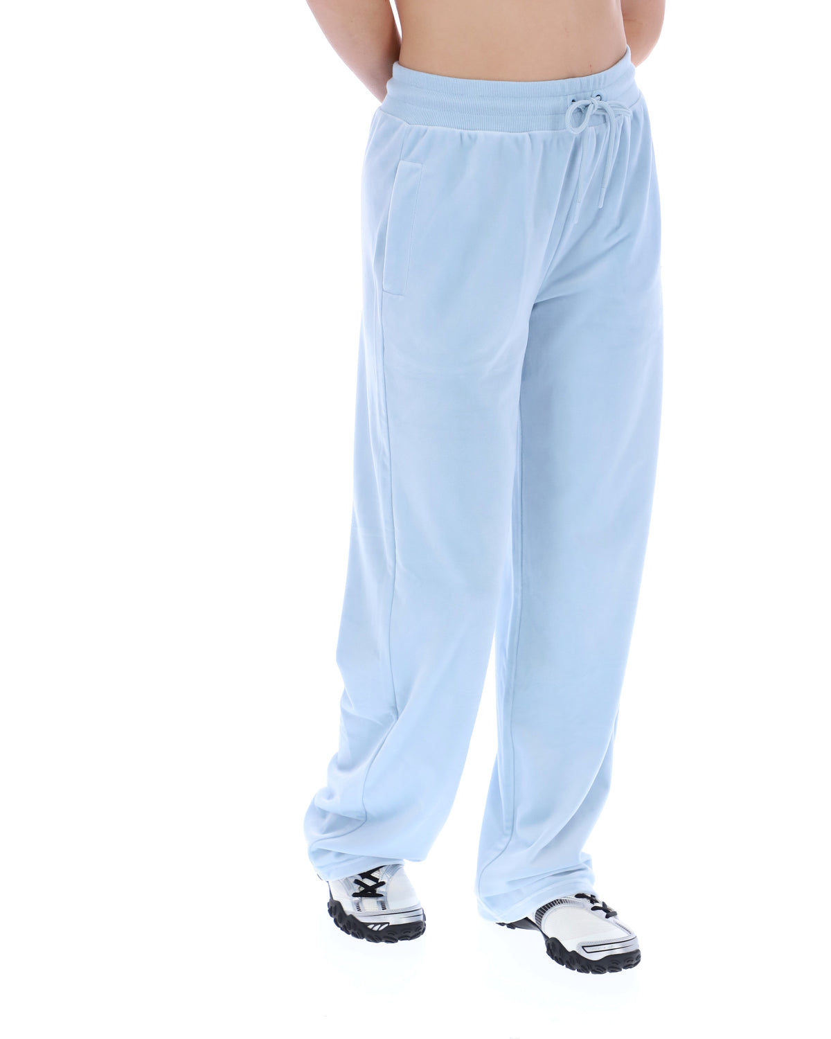 Light blue sweatpants worn by a person on a white background