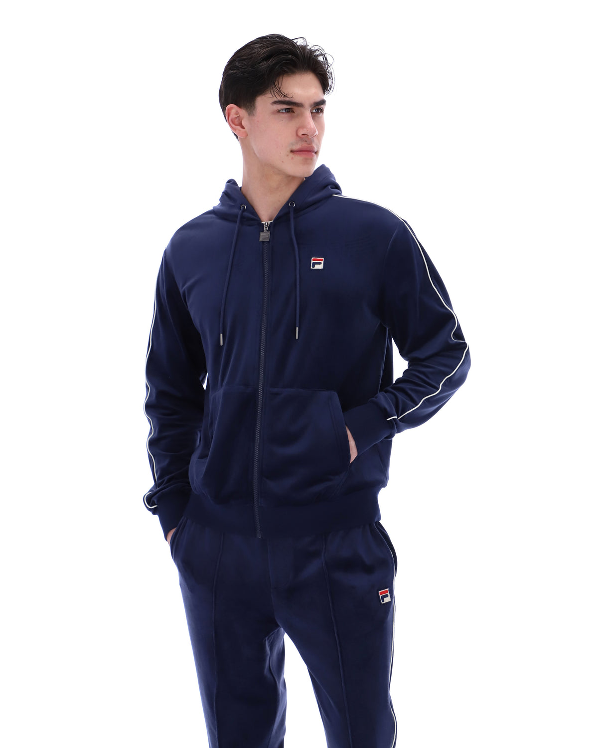 Displays a model wearing the Navy 'Fila' branded Italo Velour Hoodie