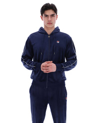 Displays a model wearing the Navy 'Fila' branded Italo Velour Hoodie