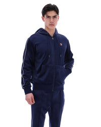 Displays a model wearing the Navy 'Fila' branded Italo Velour Hoodie