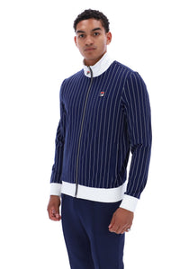 A man modeling a navy blue pinstriped zip-up jacket with white trim and a small red, white, and blue Filson logo on the chest, paired with navy pants, against a plain white background.