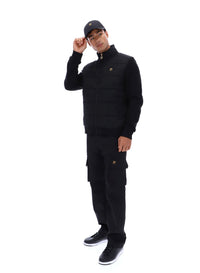 Displays a model wearing the Black 'FILA' branded Jerry Full Zip Padded Jacket