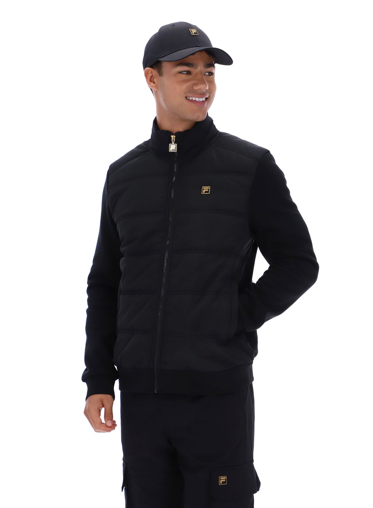 Displays a model wearing the Black 'FILA' branded Jerry Full Zip Padded Jacket