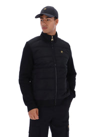 Displays a model wearing the Black 'FILA' branded Jerry Full Zip Padded Jacket