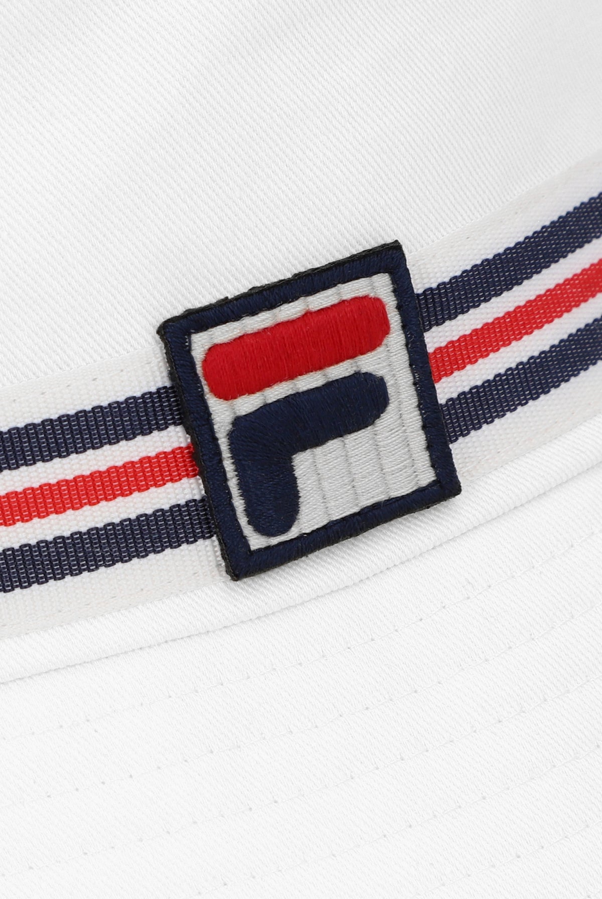 A white bucket hat with a red, blue, and white striped detail around the base and the FILA logo on the front.
