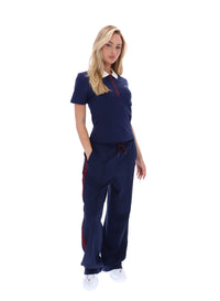 Displays a model wearing the Navy 'FILA' branded Juno Fitted Iconic Polo