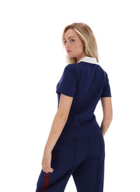 Displays a model wearing the Navy 'FILA' branded Juno Fitted Iconic Polo