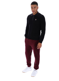 Displays a model wearing the Black 'FILA' branded Kobe Striped Knit Polo
