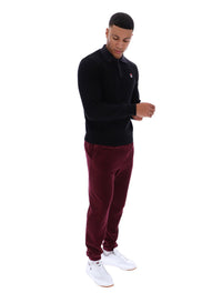 Displays a model wearing the Black 'FILA' branded Kobe Striped Knit Polo