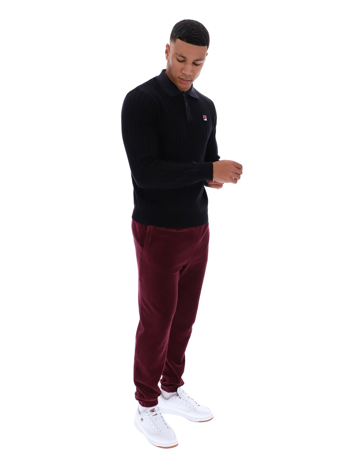 Displays a model wearing the Black 'FILA' branded Kobe Striped Knit Polo