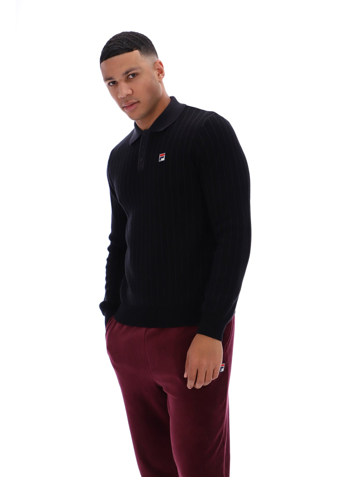 Displays a model wearing the Black 'FILA' branded Kobe Striped Knit Polo