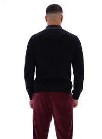 Displays a model wearing the Black 'FILA' branded Kobe Striped Knit Polo