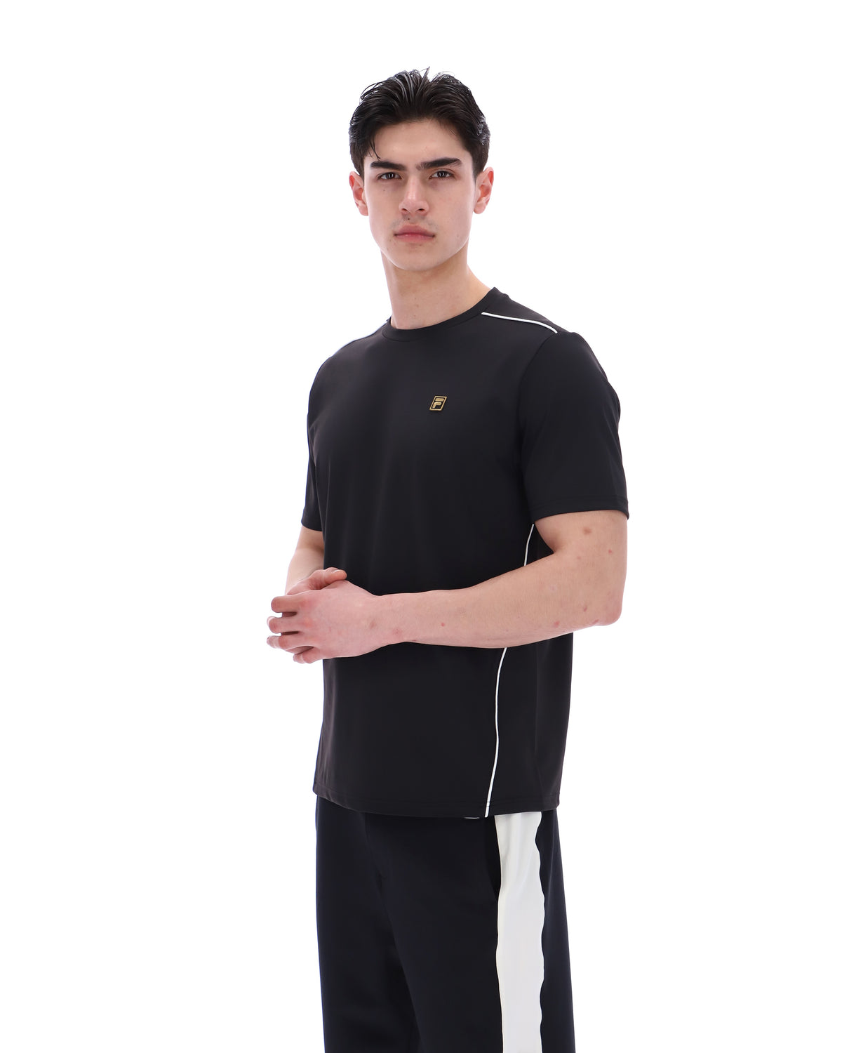 Man wearing a black outfit with a logo on a white background