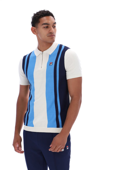A man wearing a sleeveless polo shirt with vertical light blue, white, and navy stripes, paired with navy pants, against a plain white background.