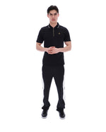 Man wearing a black outfit with white stripes on a white background