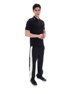 Man wearing a black polo shirt and black pants with a white stripe on a white background
