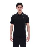 Man wearing a black polo shirt with a small logo on a white background