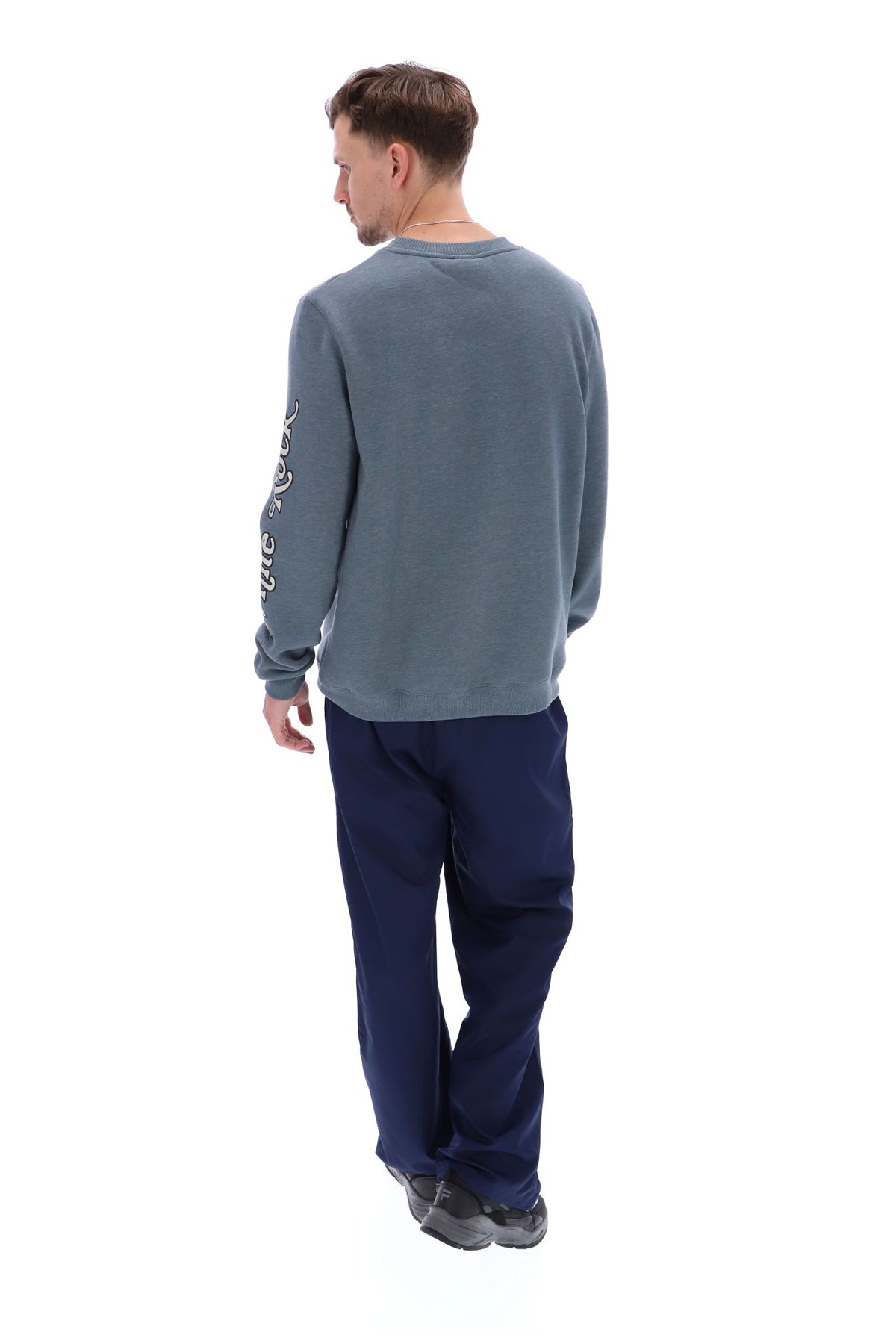 Displays a model wearing the Stormy Weather 'FILA' branded Len Graphic Crew Sweatshirt