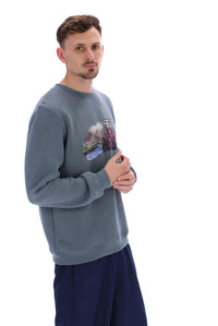 Displays a model wearing the Stormy Weather 'FILA' branded Len Graphic Crew Sweatshirt