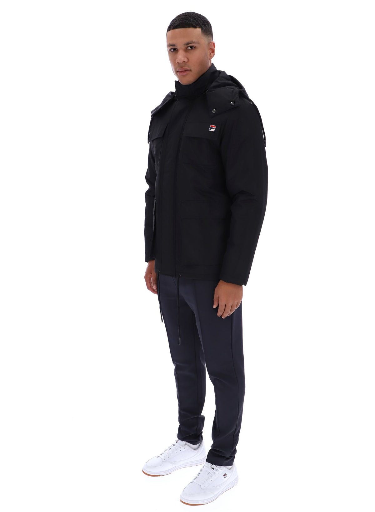 Displays a model wearing the Black 'FILA' branded Liam Cargo Padded Jacket