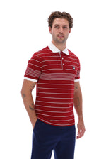 Displays a model wearing the Sun Dried 'FILA' branded Tomato/ White Logan Stripe Polo