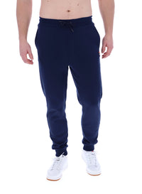 A person standing and wearing navy blue Lonny drawstring joggers with a drawstring waistband and cuffed design, featuring FILA logo branded on the waistband.