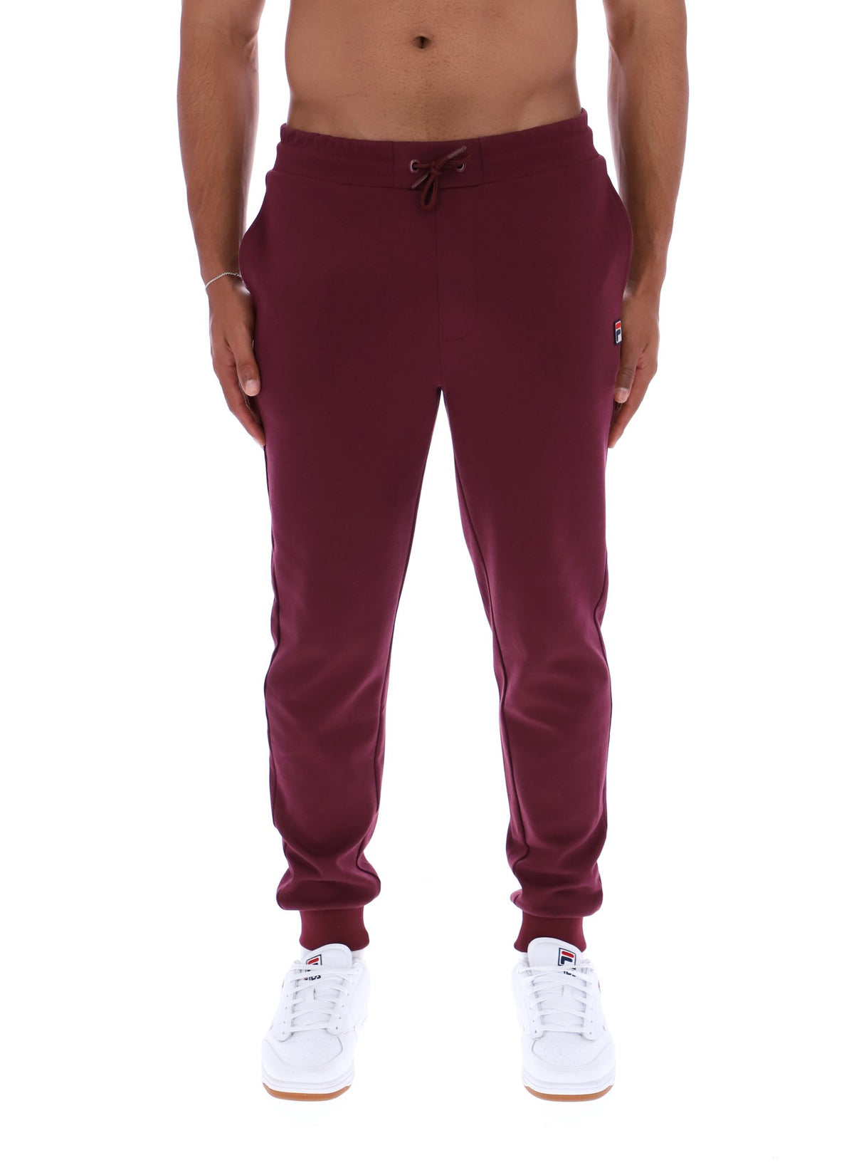 Maroon sweatpants worn by a person on a white background