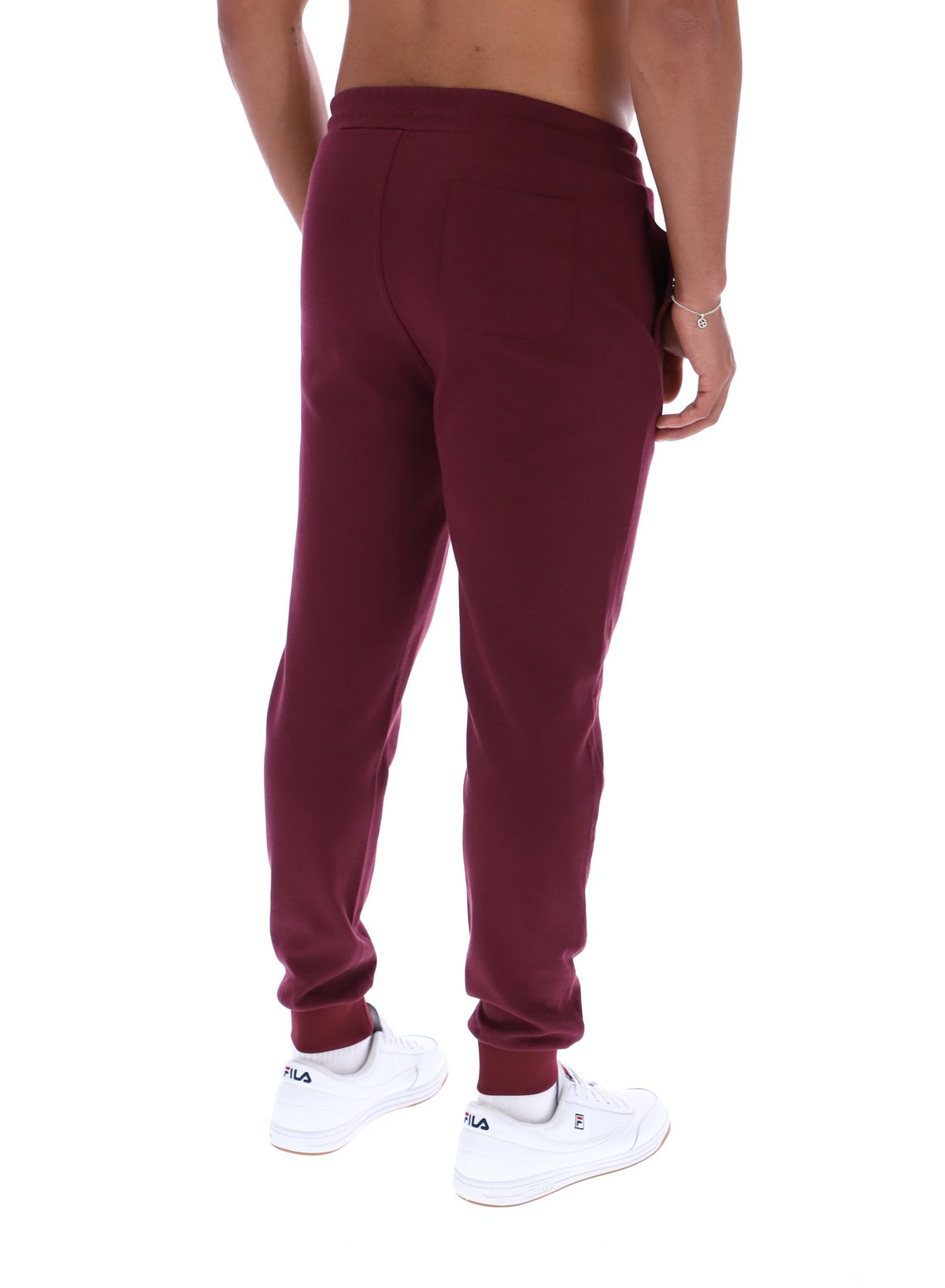 Maroon sweatpants worn by a person on a white background