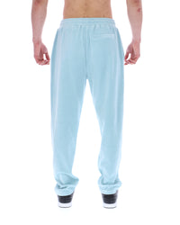 Light blue velour sweatpants worn by a person on a white background