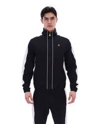 Man wearing a black tracksuit with white stripes on a white background