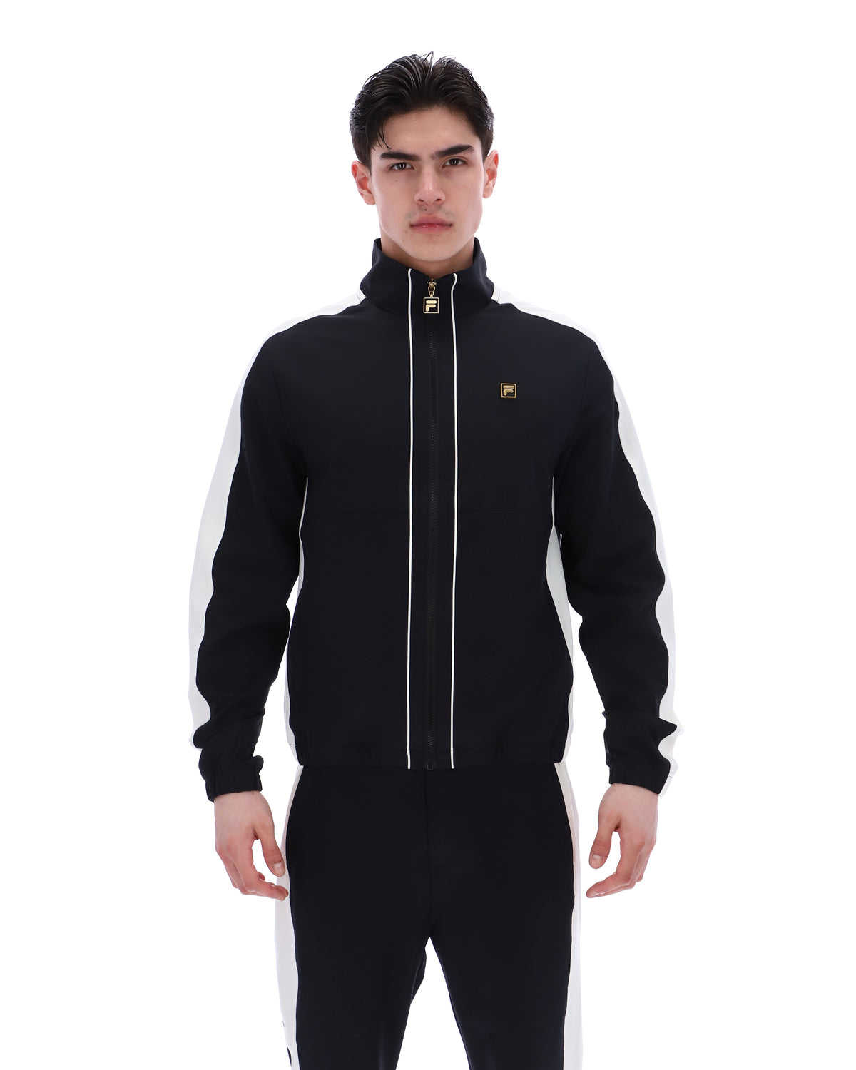 Man wearing a black tracksuit with white stripes on a white background