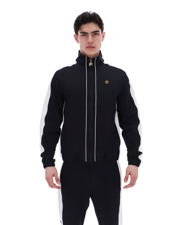 Man wearing a black tracksuit with white stripes on a white background