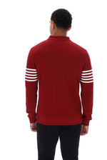 A man viewed from the back wearing a red long-sleeve quarter-zip sweatshirt with white stripes on the sleeves, paired with black pants, against a plain white background.