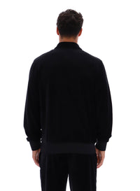 Displays a model wearing the Black 'FILA' branded Malakai Striped Track Top