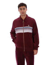 Man wearing a burgundy track top with a FILA logo on a white background