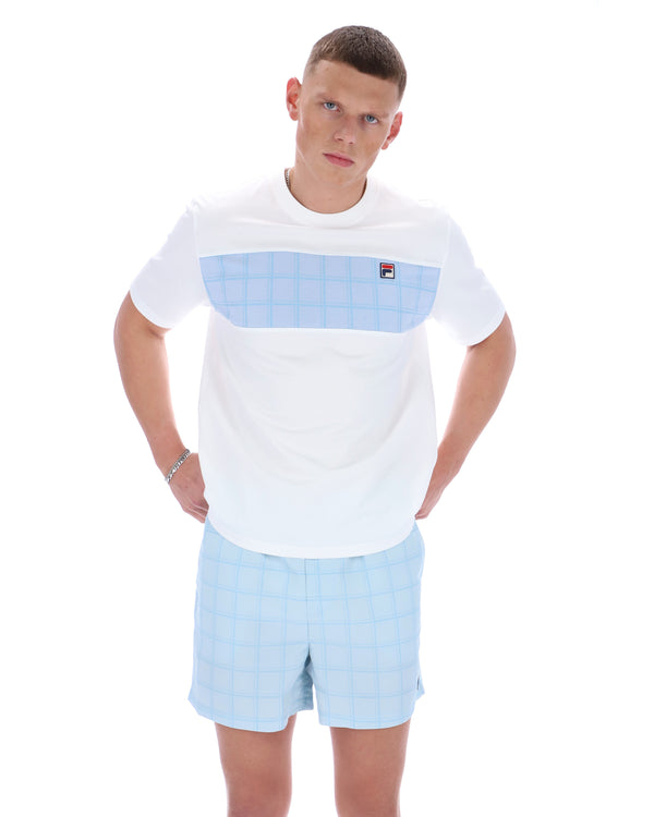 Man wearing a white t-shirt with a blue pocket and light blue shorts on a white background