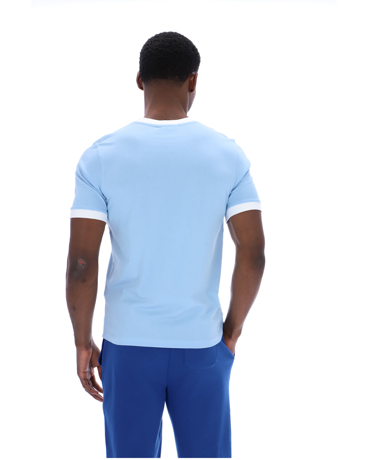Person wearing a light blue t-shirt and dark blue shorts on a white background