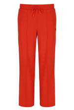 Orange sweatpants with a small FILA logo on a white background