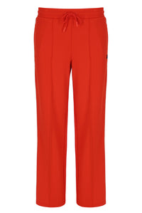 Orange sweatpants with a small FILA logo on a white background