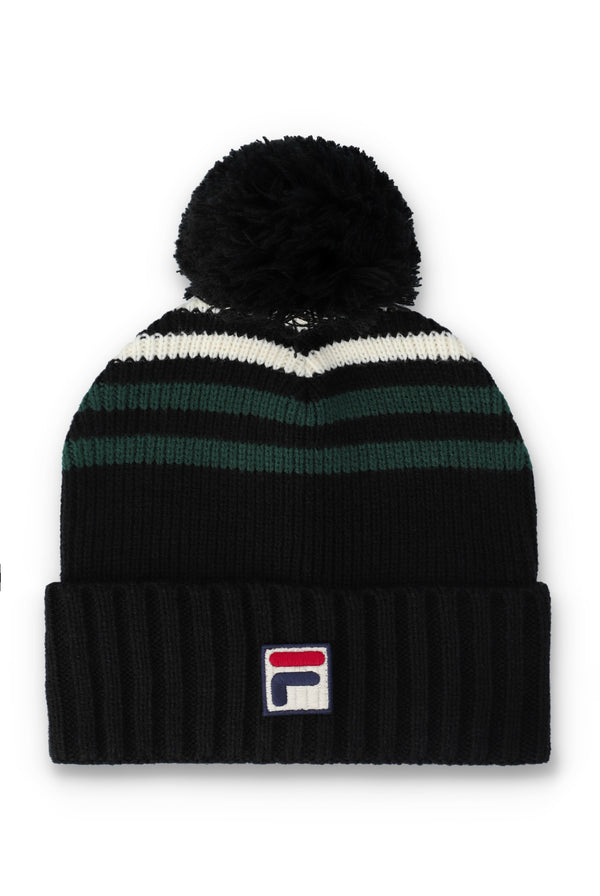 A black knit pom-pom beanie with horizontal stripes in white and dark green, featuring a small embroidered Fila logo on the front cuff.