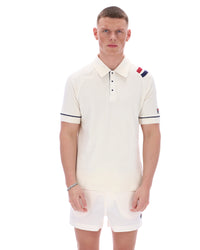 Man wearing a white polo shirt with colorful accents on a white background