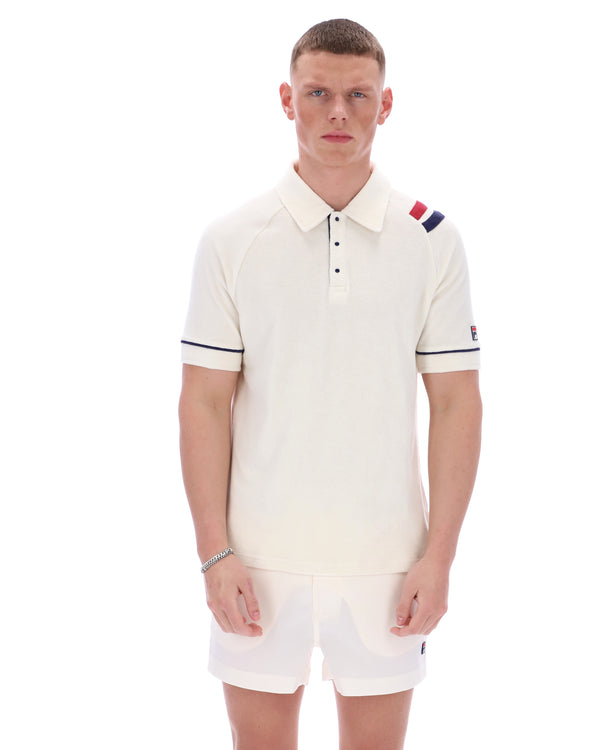 Man wearing a white polo shirt with colorful accents on a white background