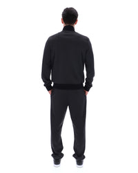 Displays a model wearing the Black 'FILA' branded Mathers Herringbone Track Top