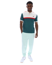 Man wearing a green and white outfit with a red stripe on a white background