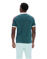 Man wearing a teal t-shirt with red and white accents on a white background
